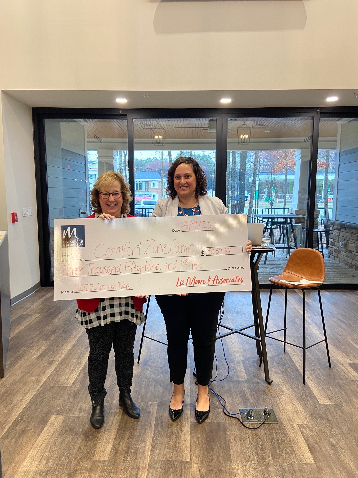 Comfort Zone Camp Presented with Money Raised by Liz Moore Richmond Office